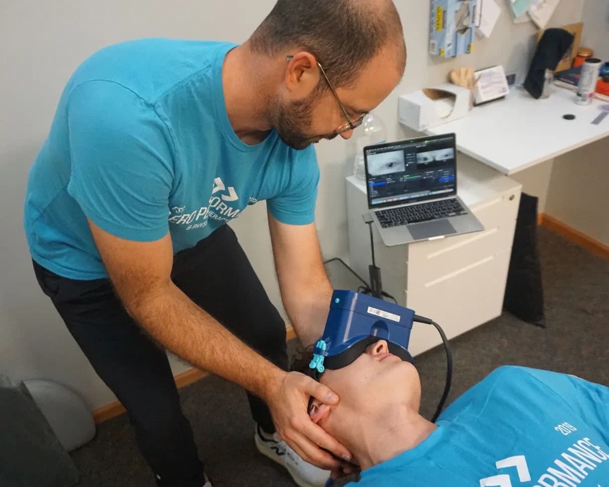 Aero Performance physical therapist using infrared video goggles to track a patient’s eye movements during a vestibular and dizziness evaluation in Coralville, Iowa